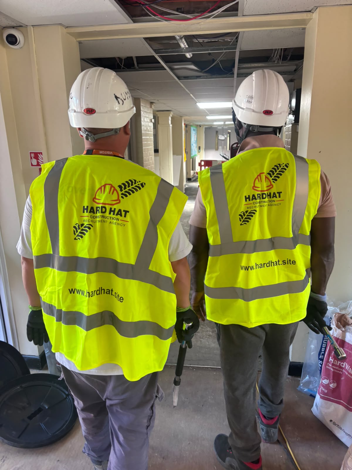 Hard Hat Recruitment operatives in branded hi-vis vests on site